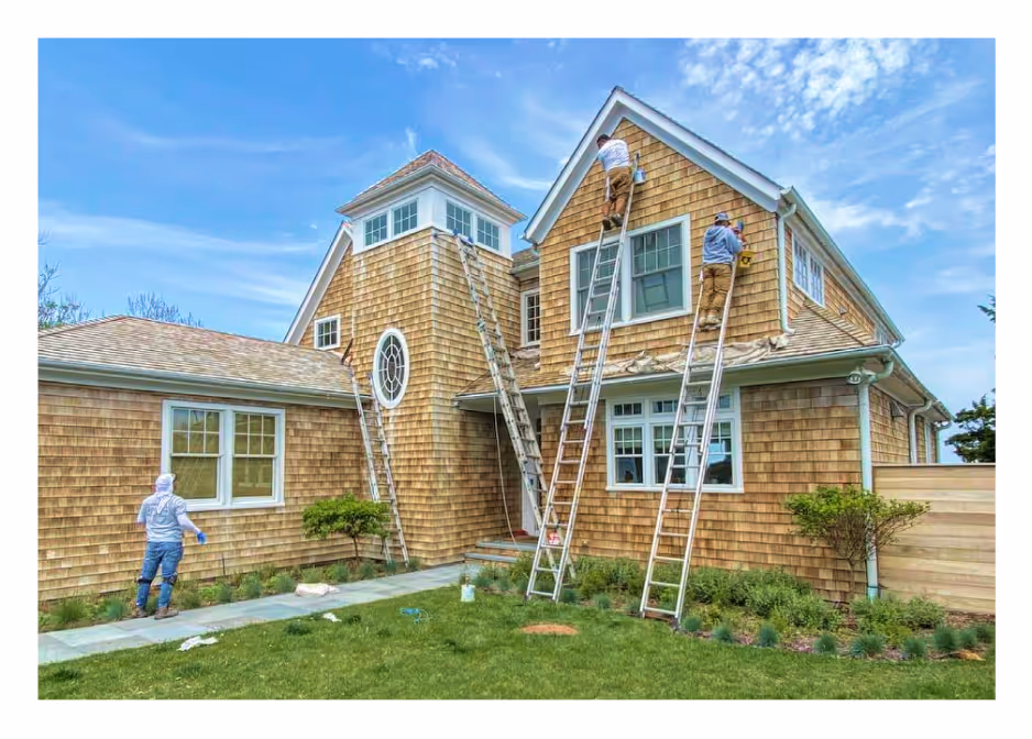 Professional painters from Palencia’s Painting & Window Cleaning restoring the exterior of a cedar-shingle Long Island home