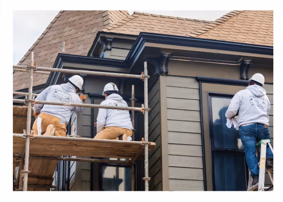 Team of painters from Palencia’s Painting & Window Cleaning restoring a house exterior with precise detailing and scaffolding setup